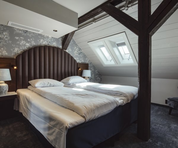 Deluxe room with double bed beneath the sloping ceiling