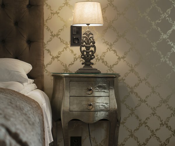 Bedside table with lamp in the deluxe room
