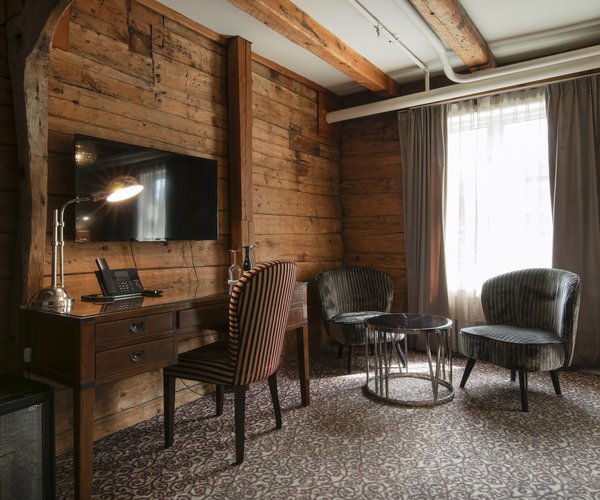 Desk and armchairs by the window in the deluxe room