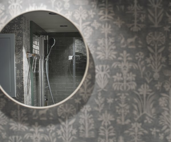 Round mirror in the deluxe room bathroom