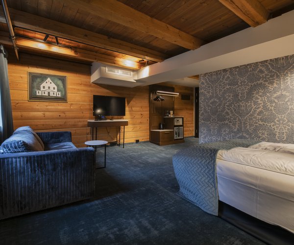 Deluxe room with double bed and exposed beams