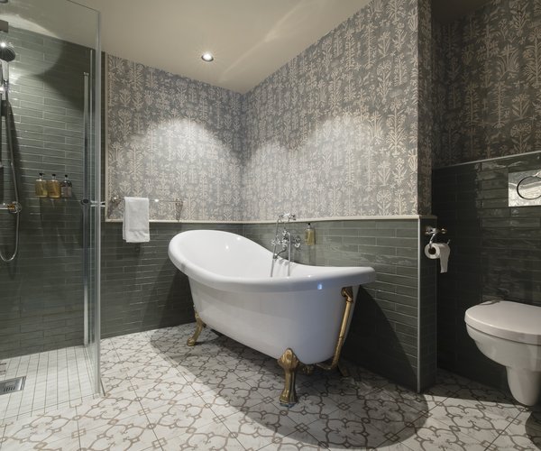 Bath and shower in the deluxe room with sloped ceiling