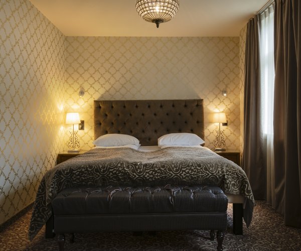 Junior suite bedroom with double bed and patterned walls