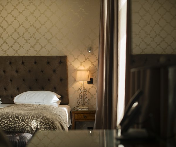 Double bed against the junior suite's patterned wall