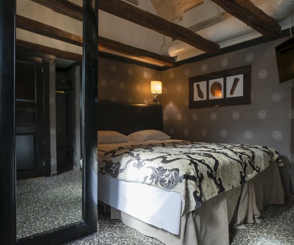 Petite standard room with double bed beneath the sloping ceiling