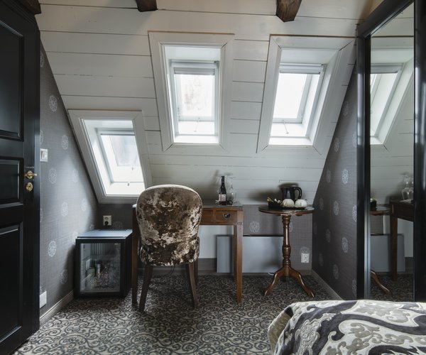 Petite standard room with double bed beneath the skylights