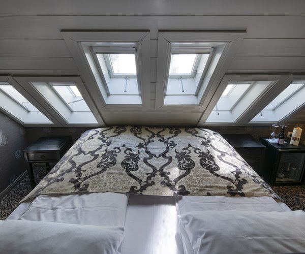 Double bed beneath the skylights in the petite standard room