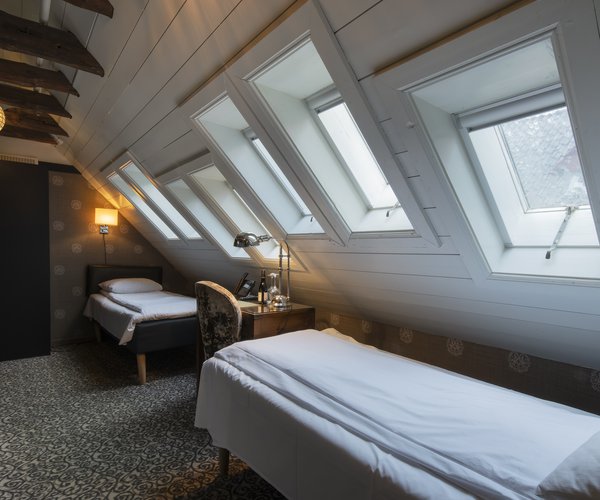 Petite twin standard room with single beds beneath the sloping ceiling