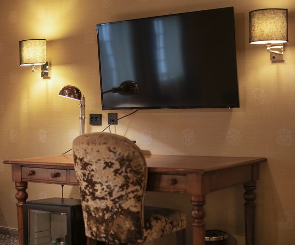 Desk, armchair and television in the suite's sitting area